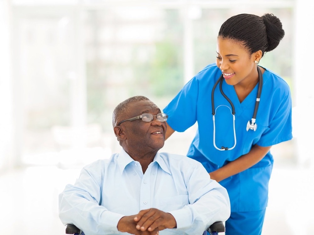 Nurse supporting a senior at home